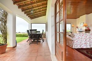 an open door to a patio with a table and chairs at Casa do Moinho in Ulgueira