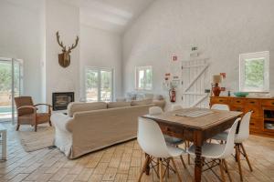 a living room with a couch and a table at Casa do Sobreiro in Alcácer do Sal