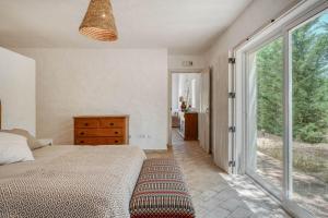 a bedroom with a bed and a large window at Casa do Sobreiro in Alcácer do Sal +15 photos
