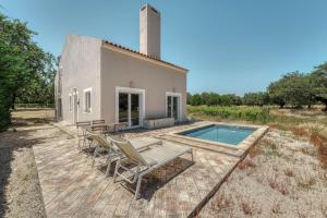 a villa with a swimming pool and a house at Casa do Sobreiro in Alcácer do Sal