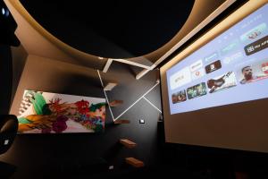 a projection screen with a presentation on a wall at Mariposa cinema in Grumo Appula