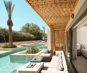 an outdoor patio with a pool and a villa at Mitsis Selection Rinela in Kokkini Khanion