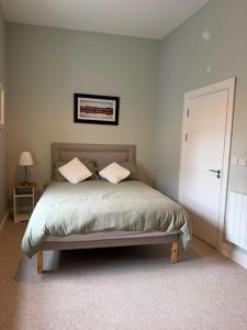 a bedroom with a bed with two pillows on it at The Gate House in Galway