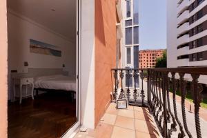 a balcony with a bed in a bedroom at Hostal Costa Coruña in A Coruña