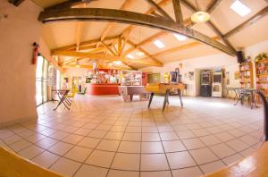 a large room with a table and chairs in it at Chalet charmant à Saint-Jean-du-Gard in Saint-Jean-du-Gard