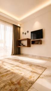 a living room with a flat screen tv on a wall at Beachside Agatti Resort in Agatti