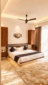 a bedroom with a large bed and a ceiling fan at Beachside Agatti Resort in Agatti