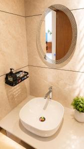 a bathroom with a white sink and a mirror at Beachside Agatti Resort in Agatti +30 photos