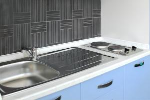 a kitchen with a sink and a stove at Comfortable Studio in Nicolosi, 25 m² in Nicolosi