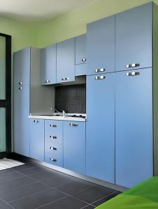 a kitchen with blue cabinets in a room at Comfortable Studio in Nicolosi, 25 m² in Nicolosi
