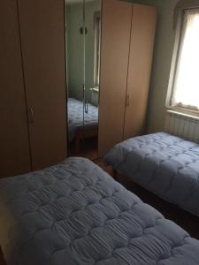 a bedroom with two beds and a mirror at Spacious and Charming House in Vozuća with Large Garden in Vozuća