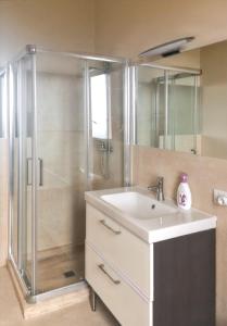 a bathroom with a shower and a sink and a mirror at Charming House in Gallipoli + Terrace in Gallipoli