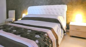 a bedroom with a white bed with a black and white blanket at Charming House in Gallipoli + Terrace in Gallipoli +13 photos