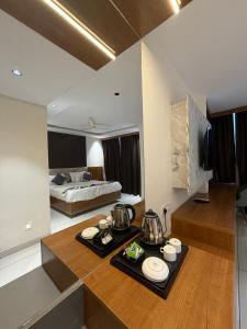 a room with a bed and a table with dishes on it at Senary's Nest INN in Kyātsandra