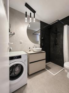 a bathroom with a washing machine and a sink at dom na gwarnej in Osłonin