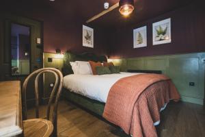 a bedroom with a bed with a blanket on it at The Linen Rooms in Knutsford