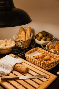 a table topped with baskets of bread and baskets of breadsticks at Esteem Tour Eiffel in Paris +46 photos