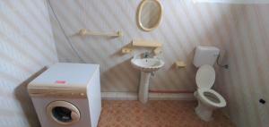 a small bathroom with a toilet and a sink at Family apartment with pool in Trou-aux-Biches, 80 m² in Trou aux Biches +5 photos
