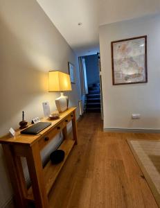a room with a desk with a laptop on it at Balnain Street Cottage in Inverness
