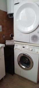 a washing machine with a microwave on top of it at Villa sul lago in Jajce