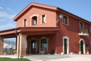 a red brick house with windows and plants on it at Exquisite Retreat in Segni in Colleferro