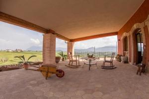 a patio with a table and chairs and a view at Exquisite Retreat in Segni in Colleferro