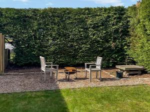 two chairs and a table and a bench in a yard at The Garden Pod in Brechin