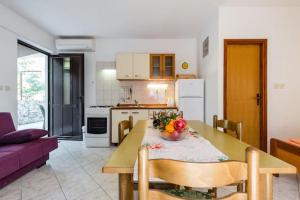 a kitchen with a table with a bowl of fruit on it at Charming Studio in Zavala - 25 m² - Parking Included in Zavala +28 photos