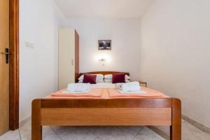 a bedroom with a bed with two pillows on it at Charming Studio in Zavala - 25 m² - Parking Included in Zavala