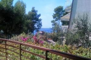 a balcony with a wooden fence and flowers at Charming Studio in Zavala - 25 m² - Parking Included in Zavala