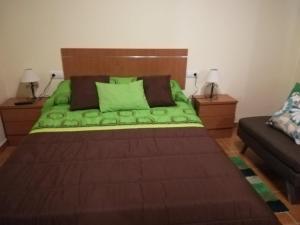a bedroom with a bed with a wooden head board at Charming Apartment La Oliva 30 sqm + Terrace in La Oliva