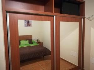 a mirrored closet with a bed in a room at Charming Apartment La Oliva 30 sqm + Terrace in La Oliva