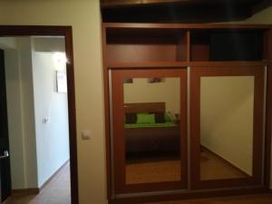 a mirror in a room with a bed in the background at Charming Apartment La Oliva 30 sqm + Terrace in La Oliva