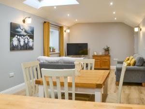 a living room with a table and a couch at Bumble Cottage in Cockermouth +11 photos