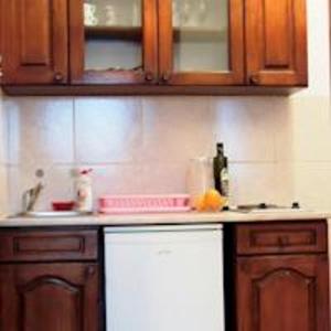 a kitchen with wooden cabinets and a counter top at Sea View Apartment - Ulcinj - 40 sqm in Ulcinj +7 photos