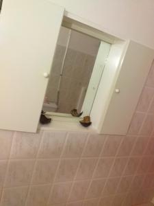 a bathroom with a mirror and a tiled floor at Appartement charmant Morne-À-l'Eau in Morne-à-lʼEau