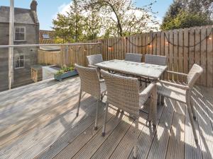 a patio with a table and chairs on a deck at Struan in Kilconquhar