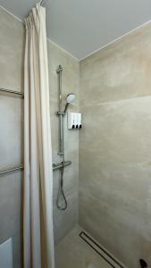 a shower with a shower curtain in a bathroom at CasaMare Lagonisi Athens Riviera Luxury modern villas apartment's in Lagonissi +38 photos