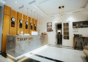 a lobby with a reception desk and clocks at Baden-Baden Hotel Tashkent in Tashkent +47 photos