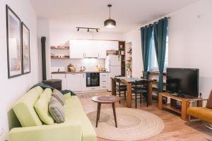 a living room with a couch and a kitchen at Casa Hollaj in Vladimir