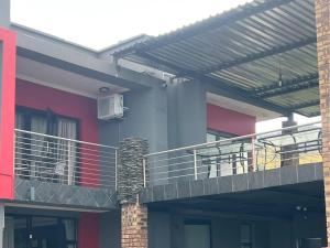 a building with a deck and a balcony at Vista Royale Luxury Villas in Mbabane