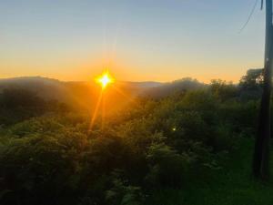 an image of the sun setting over a field at Vista Royale Luxury Villas in Mbabane