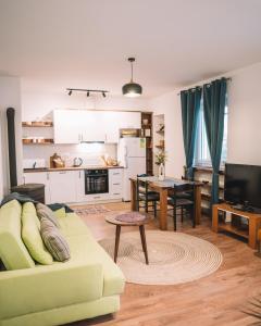 a living room with a couch and a kitchen at Casa Hollaj in Vladimir +22 photos