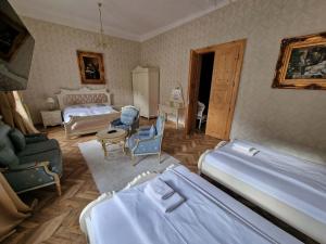a bedroom with two beds and a table and chairs at Apartmány Svätá Barborka in Banská Štiavnica