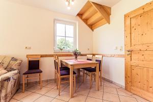 a kitchen and dining room with a table and chairs at Waldlust in Abtsgmünd