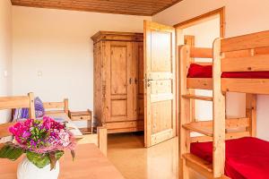 a room with two bunk beds and a vase of flowers at Waldlust in Abtsgmünd