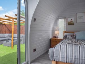 a bedroom with a bed and a balcony at Laurel Pod - Uk47203 in Westhead