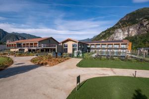 a resort with a mountain in the background at Continental Golf Resort in Verbania