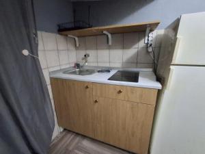 a small kitchen with a sink and a refrigerator at Casa relax Mele in Siniscola