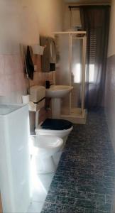 a bathroom with two toilets and a sink at Casa relax Mele in Siniscola